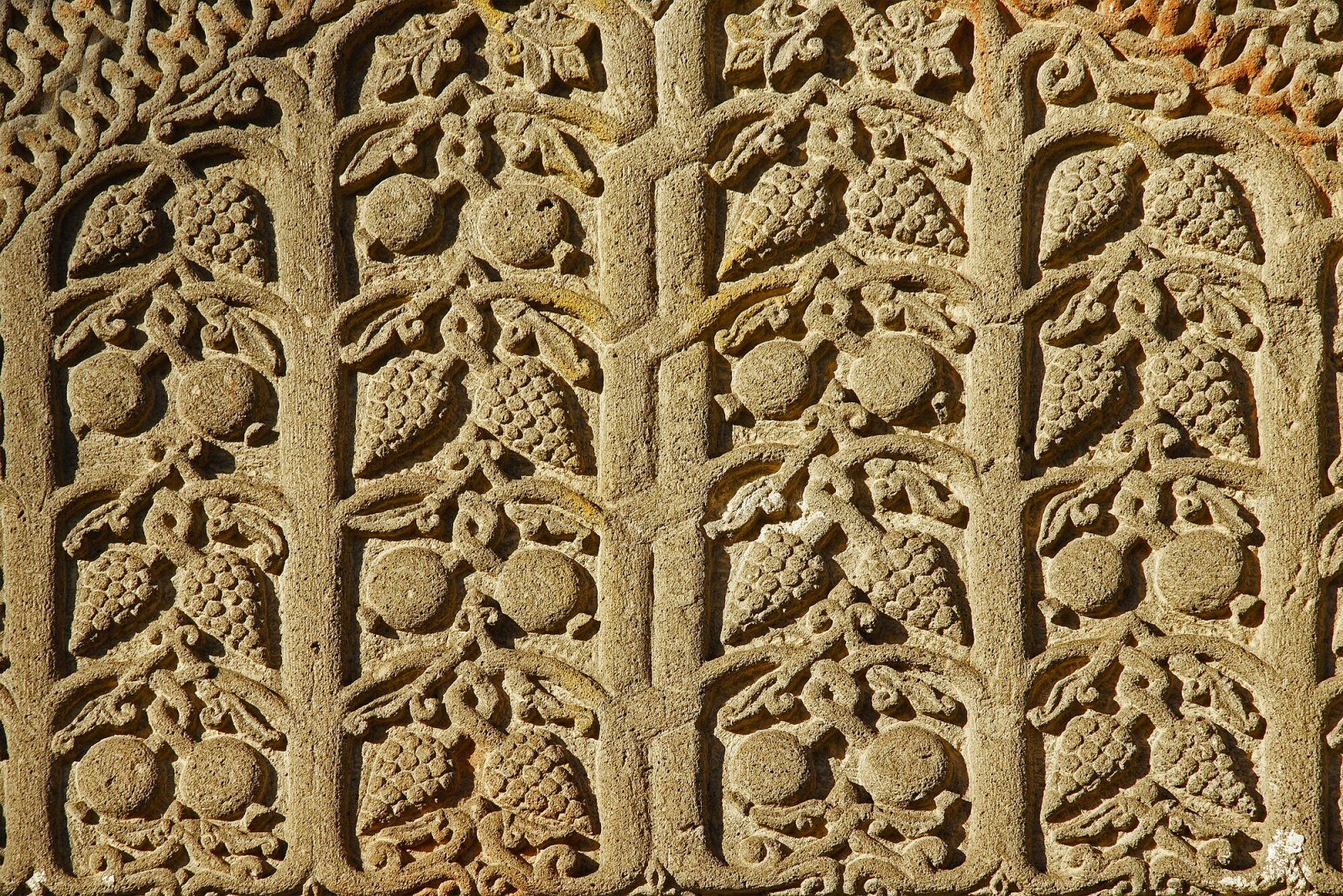 Exterior facade of Geghard Monastery with carved khachkars